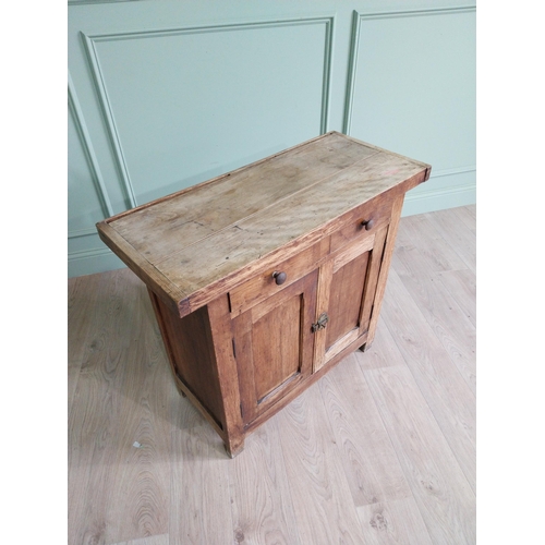 268 - Early 20th C. oak and pine cupboard with two long doors over two short drawers on square feet. {80 c... 