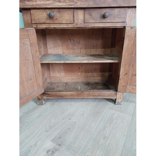 268 - Early 20th C. oak and pine cupboard with two long doors over two short drawers on square feet. {80 c... 