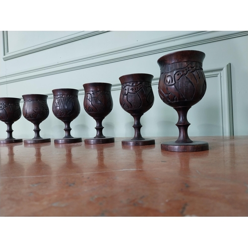 283 - Set of eight carved African hardwood goblets {16 cm H x 8 cm Dia.}.