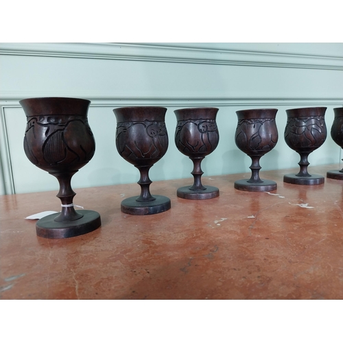 283 - Set of eight carved African hardwood goblets {16 cm H x 8 cm Dia.}.