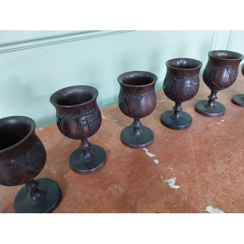 283 - Set of eight carved African hardwood goblets {16 cm H x 8 cm Dia.}.