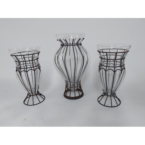 295 - Three vintage glass flower vases in metal surrounds {49 cm H x 26 cm Dia. AND 40 cm H x 20 cm Dia.}.