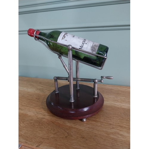 3 - Silver plated mechanical wine decanting cradle mounted on mahogany base {33 cm H x 35 cm W x 25 cm D... 