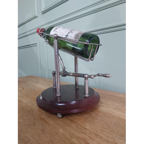 3 - Silver plated mechanical wine decanting cradle mounted on mahogany base {33 cm H x 35 cm W x 25 cm D... 