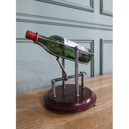 3 - Silver plated mechanical wine decanting cradle mounted on mahogany base {33 cm H x 35 cm W x 25 cm D... 