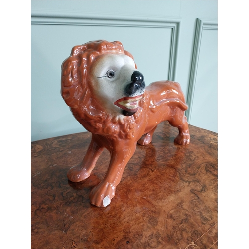 328 - Pair of early 20th C. ceramic Staffordshire Lions {27 cm H x 36 cm W x 20 cm D}.