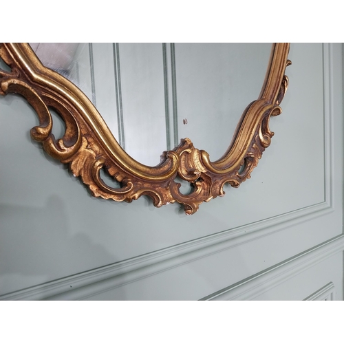 361 - Decorative giltwood wall mirror in the Rococo style {118 cm H x 81 cm W}. U