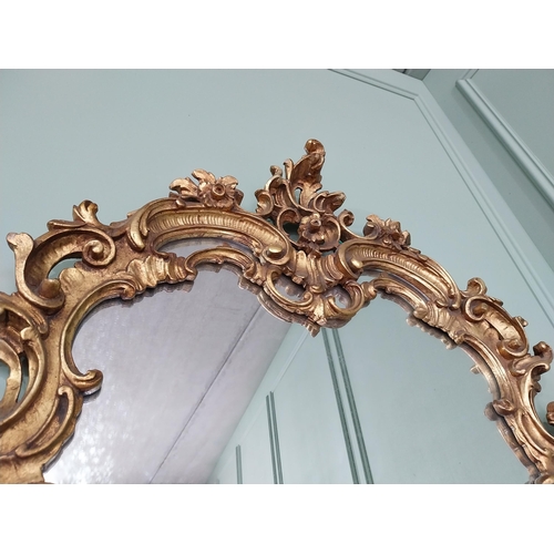 361 - Decorative giltwood wall mirror in the Rococo style {118 cm H x 81 cm W}. U