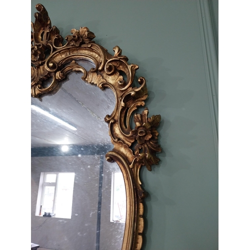 361 - Decorative giltwood wall mirror in the Rococo style {118 cm H x 81 cm W}. U