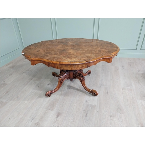 42 - Good quality burr walnut shaped centre table raised on turned column and four outswept feet {73 cm H... 