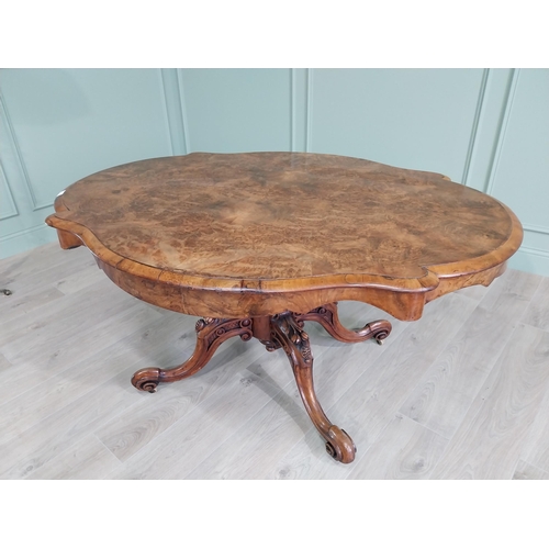 42 - Good quality burr walnut shaped centre table raised on turned column and four outswept feet {73 cm H... 