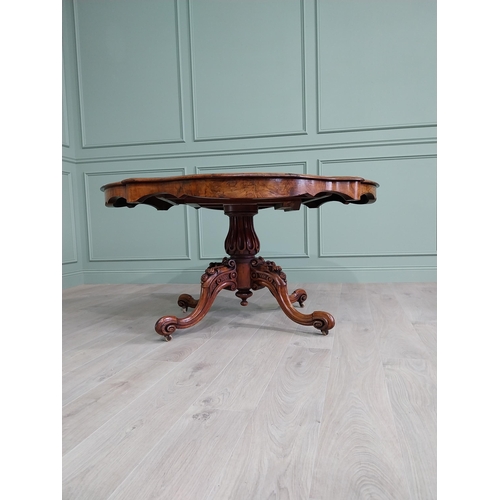 42 - Good quality burr walnut shaped centre table raised on turned column and four outswept feet {73 cm H... 