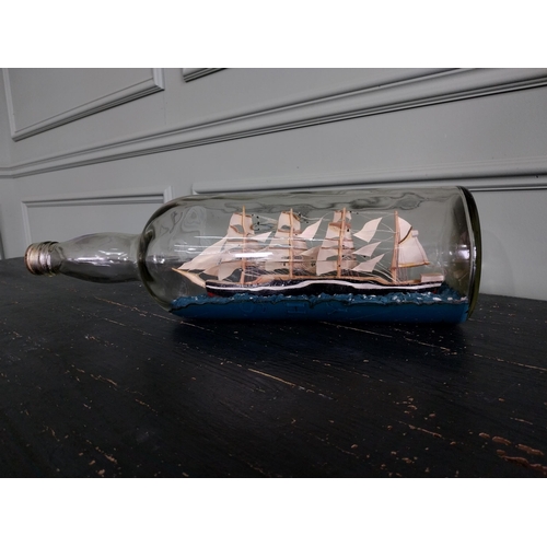 443 - Vintage ship in a bottle {24 cm H x 52 cm W x 14 cm D}.