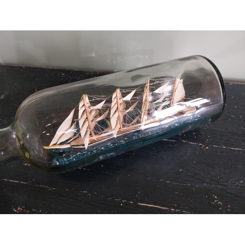 443 - Vintage ship in a bottle {24 cm H x 52 cm W x 14 cm D}.