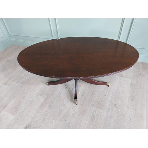 452 - Mahogany coffee table raised on turned column and three outswept legs and castors in the Regency sty... 