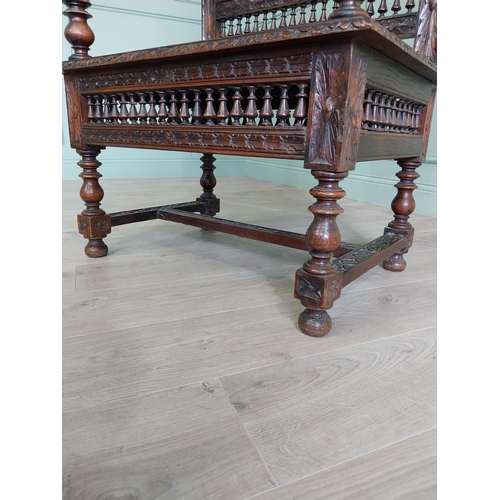 462 - 19th C. carved oak throne chair in the Tudor style {140 cm H x 80 cm W x 52 cm D}.