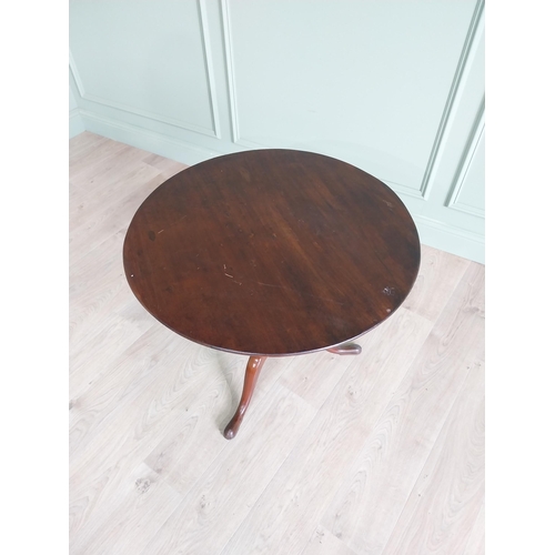 464 - Irish Georgian mahogany tilt top centre table raised on turned column and three outswept feet {68 cm... 