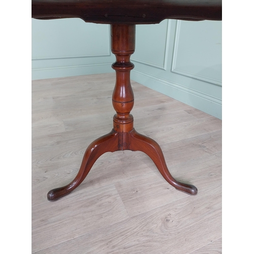 464 - Irish Georgian mahogany tilt top centre table raised on turned column and three outswept feet {68 cm... 