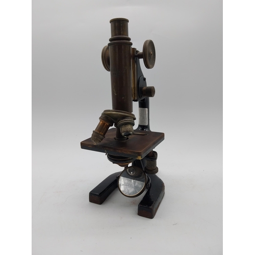 468 - Early 20th C. brass and metal microscope {36 cm H x 11 cm W x 19 cm D}.