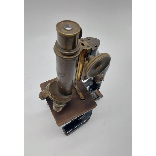 468 - Early 20th C. brass and metal microscope {36 cm H x 11 cm W x 19 cm D}.