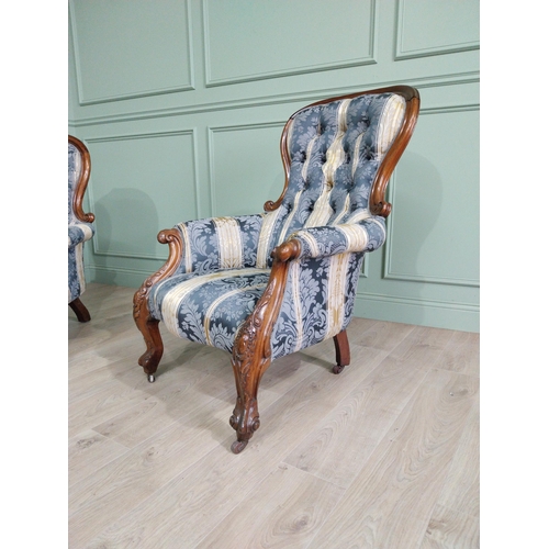 472 - Two Victorian mahogany and upholstered ladies and gents arm chairs raised on cabriole legs {100 cm H... 