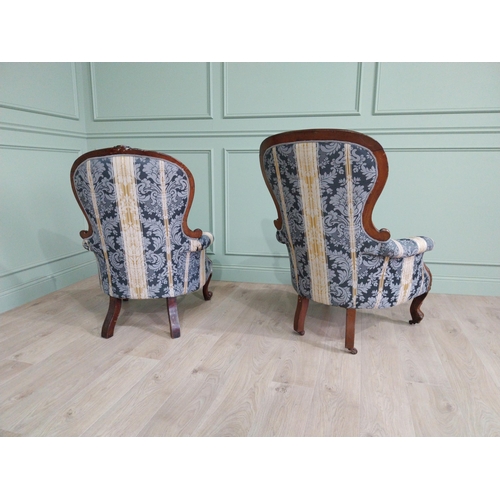 472 - Two Victorian mahogany and upholstered ladies and gents arm chairs raised on cabriole legs {100 cm H... 