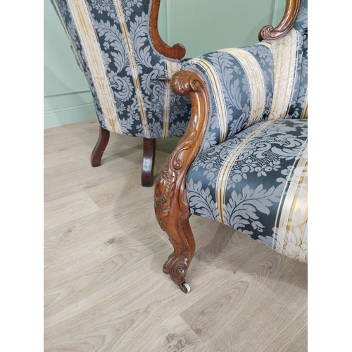 472 - Two Victorian mahogany and upholstered ladies and gents arm chairs raised on cabriole legs {100 cm H... 