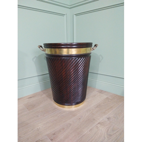 557 - Irish mahogany spiral brass bound peat bucket in the Georgian style {66cm H x 62cm Dia}