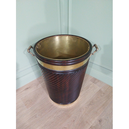 557 - Irish mahogany spiral brass bound peat bucket in the Georgian style {66cm H x 62cm Dia}