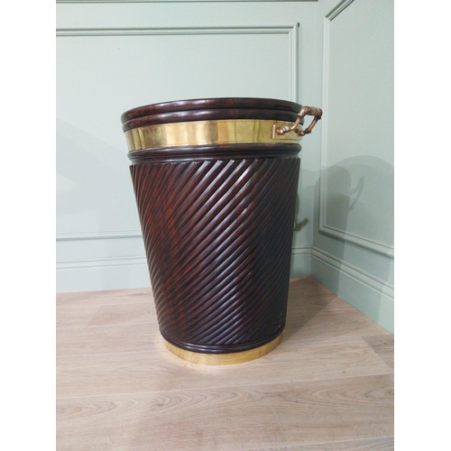 557 - Irish mahogany spiral brass bound peat bucket in the Georgian style {66cm H x 62cm Dia}