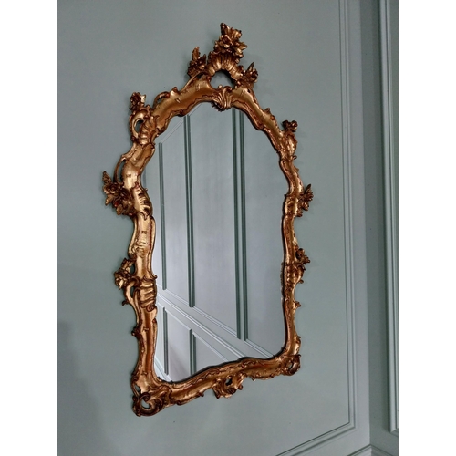 62 - Decorative giltwood wall mirror in the Rococo style {105 cm H x 70 cm W}. U