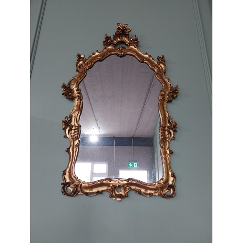 62 - Decorative giltwood wall mirror in the Rococo style {105 cm H x 70 cm W}. U