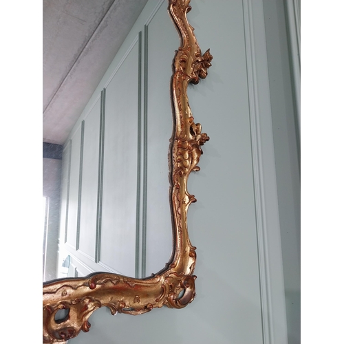 62 - Decorative giltwood wall mirror in the Rococo style {105 cm H x 70 cm W}. U