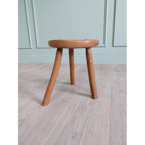 63 - 19th C. Irish painted elm three legged stool {31 cm H x 33 cm Dia.}.