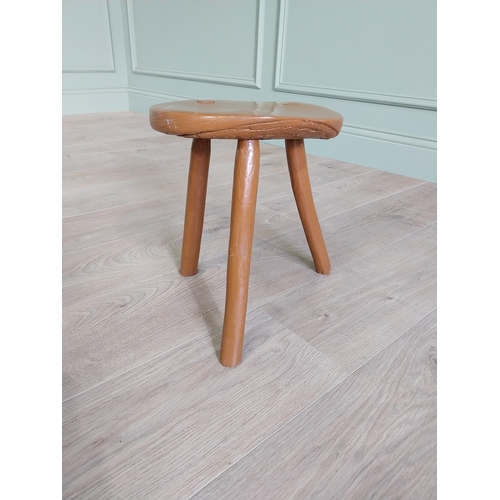 63 - 19th C. Irish painted elm three legged stool {31 cm H x 33 cm Dia.}.