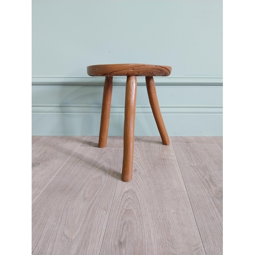 63 - 19th C. Irish painted elm three legged stool {31 cm H x 33 cm Dia.}.