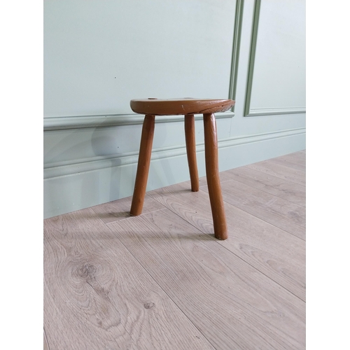 63 - 19th C. Irish painted elm three legged stool {31 cm H x 33 cm Dia.}.