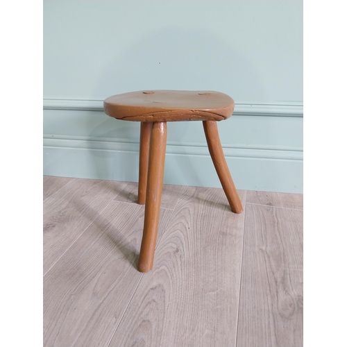 63 - 19th C. Irish painted elm three legged stool {31 cm H x 33 cm Dia.}.