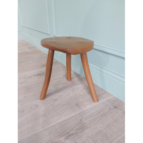 63 - 19th C. Irish painted elm three legged stool {31 cm H x 33 cm Dia.}.