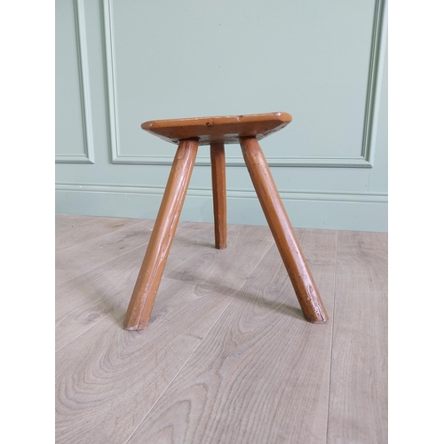 64 - 19th. C Irish painted elm three legged stool {35 cm H x 38 cm W x 26 cm D}.