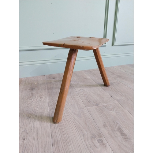 64 - 19th. C Irish painted elm three legged stool {35 cm H x 38 cm W x 26 cm D}.