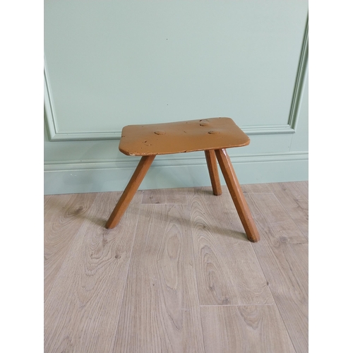 64 - 19th. C Irish painted elm three legged stool {35 cm H x 38 cm W x 26 cm D}.