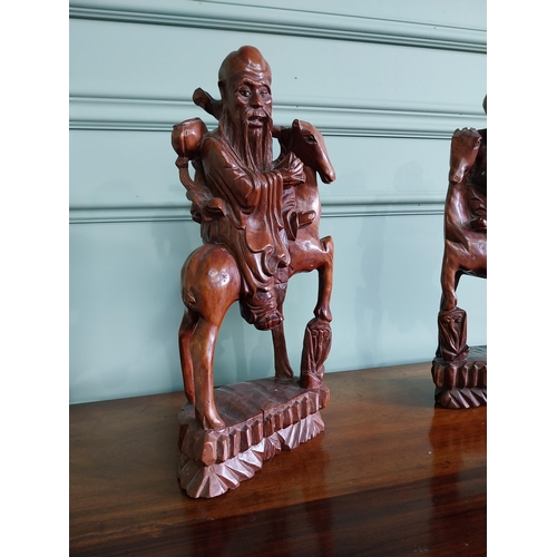 90 - Pair of Oriental carved hardwood figures {40 cm H x 20 cm W x 10 cm D}.