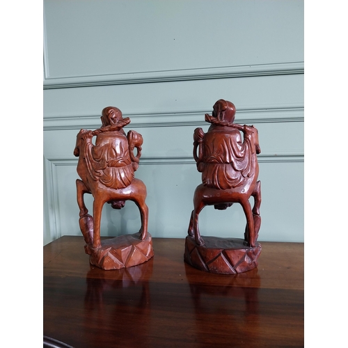 90 - Pair of Oriental carved hardwood figures {40 cm H x 20 cm W x 10 cm D}.