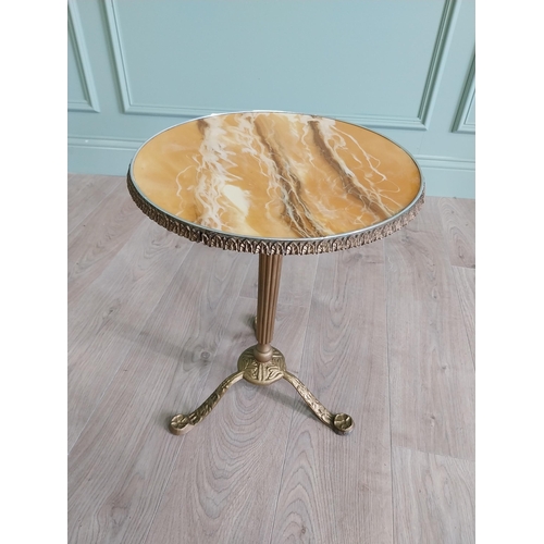 903 - Gilded metal wine table with faux marble centre raised on reeded column and three outswept legs {50 ... 