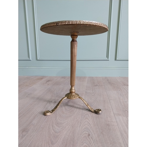 903 - Gilded metal wine table with faux marble centre raised on reeded column and three outswept legs {50 ... 