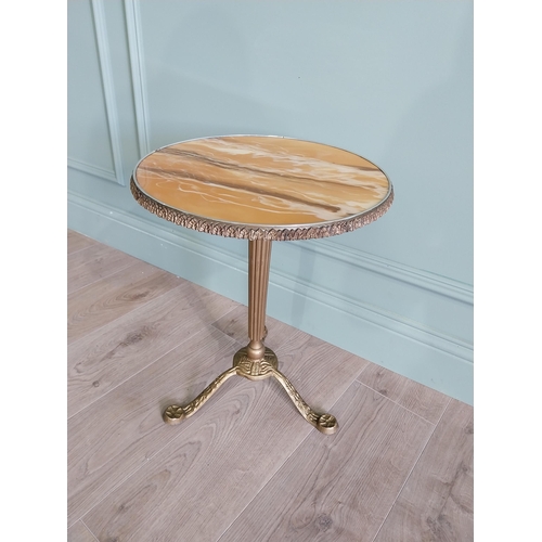 903 - Gilded metal wine table with faux marble centre raised on reeded column and three outswept legs {50 ... 