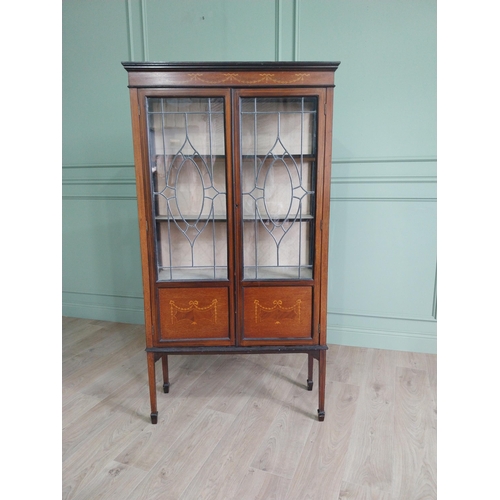 905 - Edwardian mahogany and satinwood display cabinet with two leaded glass doors raised on square tapere... 