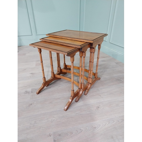 93 - 19th C. satinwood nest of three tables raised on turned legs {56 cm H x 36 cm W x 44 cm D}.