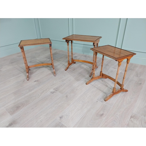 93 - 19th C. satinwood nest of three tables raised on turned legs {56 cm H x 36 cm W x 44 cm D}.